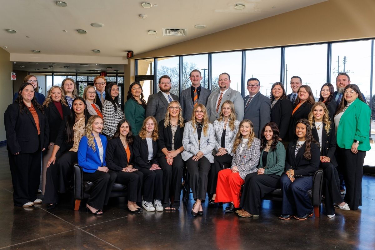 A cohort of student teachers standing for a group photo.