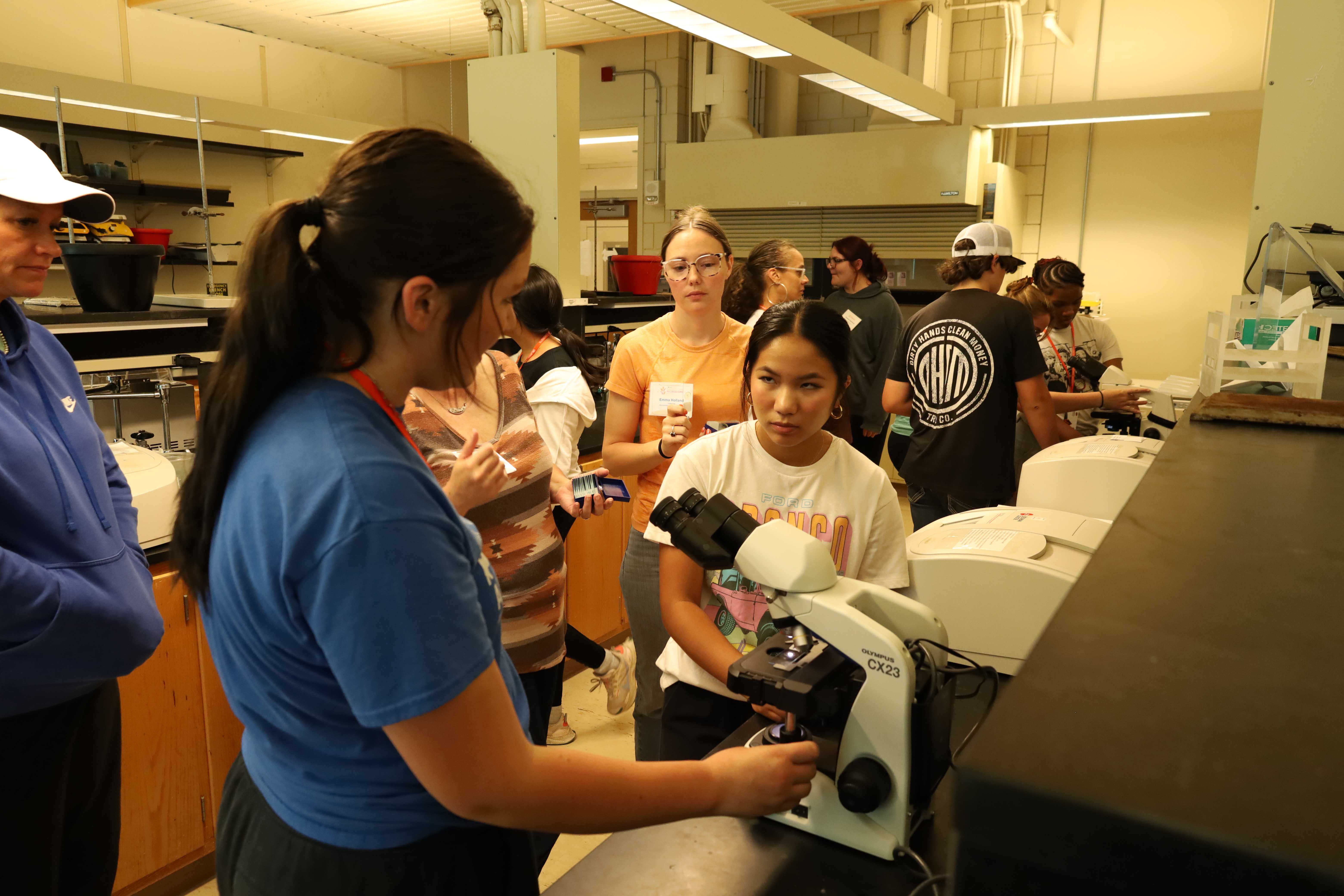 Students learning about and using microscopes