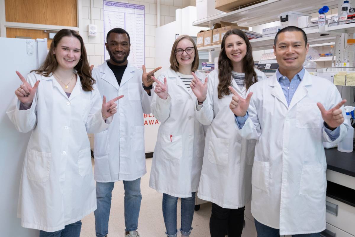 Studnets and mentor in a lab