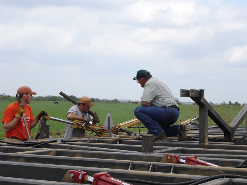 Students in a flatbed truck in a field