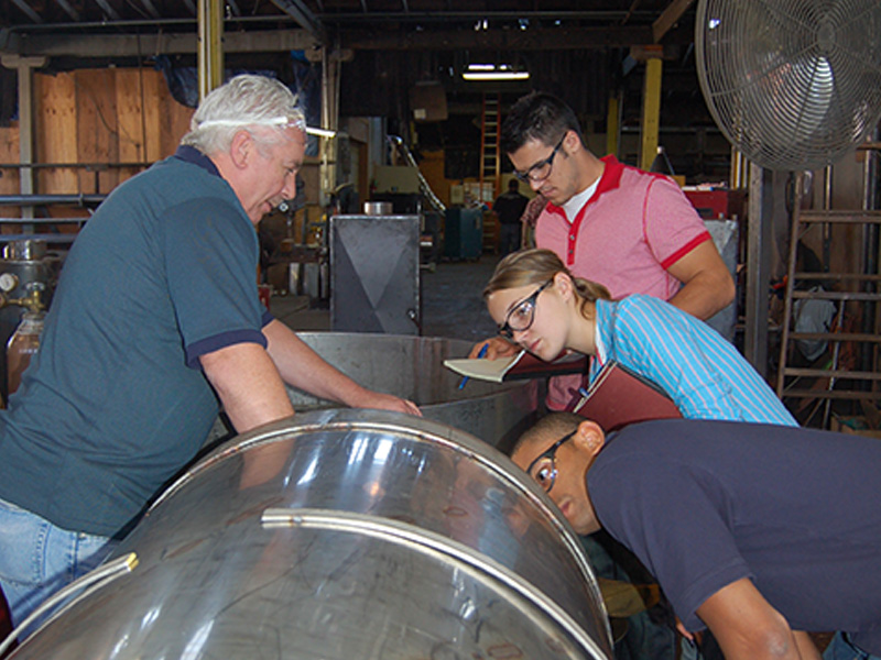 Seniors check out a large metal barrel