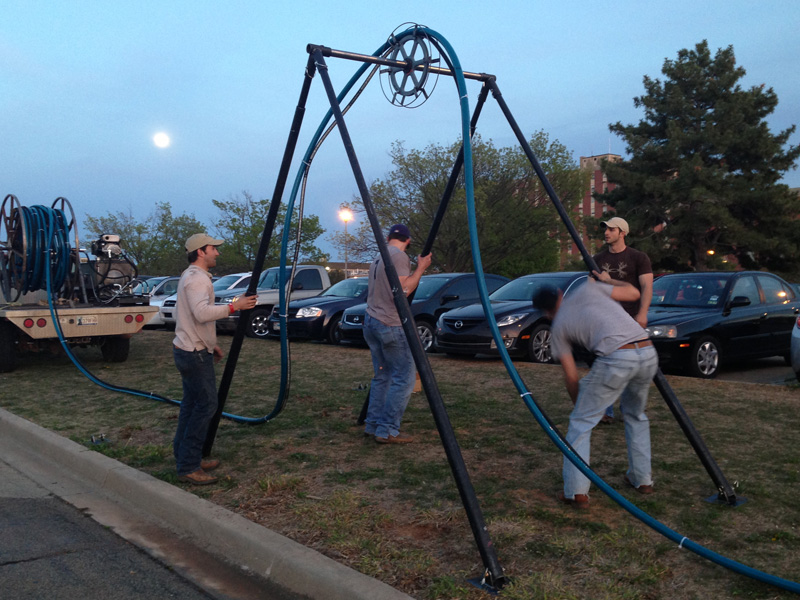 Sneiors testing their design on a vertically large metal appreatus.