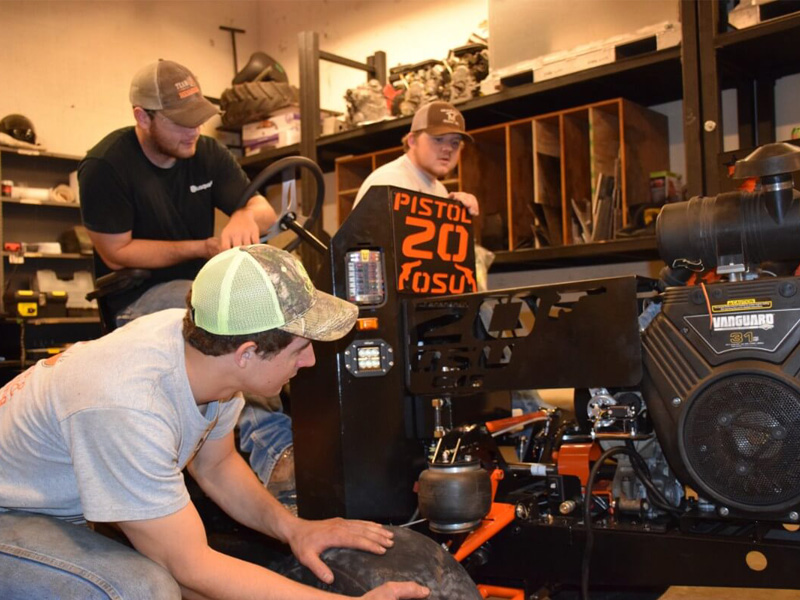 Senior design team working on a quarter scale tractor