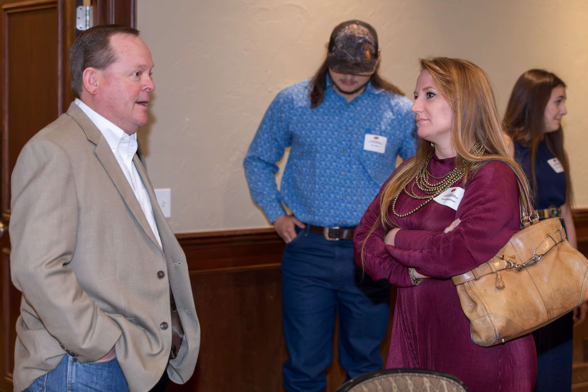 A man and a woman talking at the event.