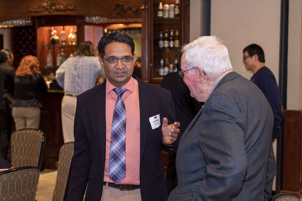 Dr. Omkar Joshi is talking to a gentleman.