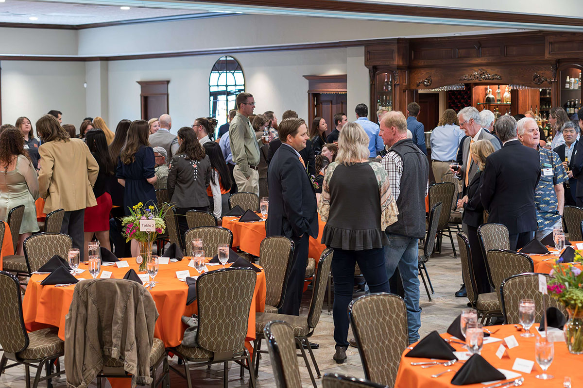 People standing around the tables at the ceremony.