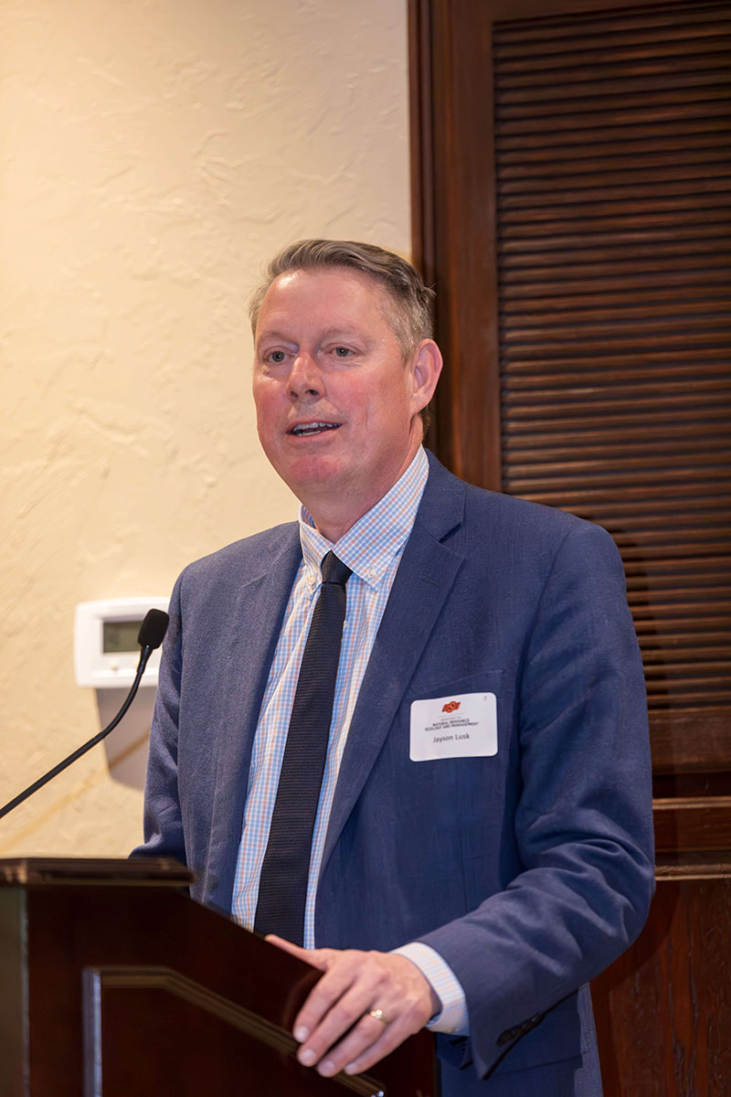 Jayson Lusk standing behind a podium giving a speech.