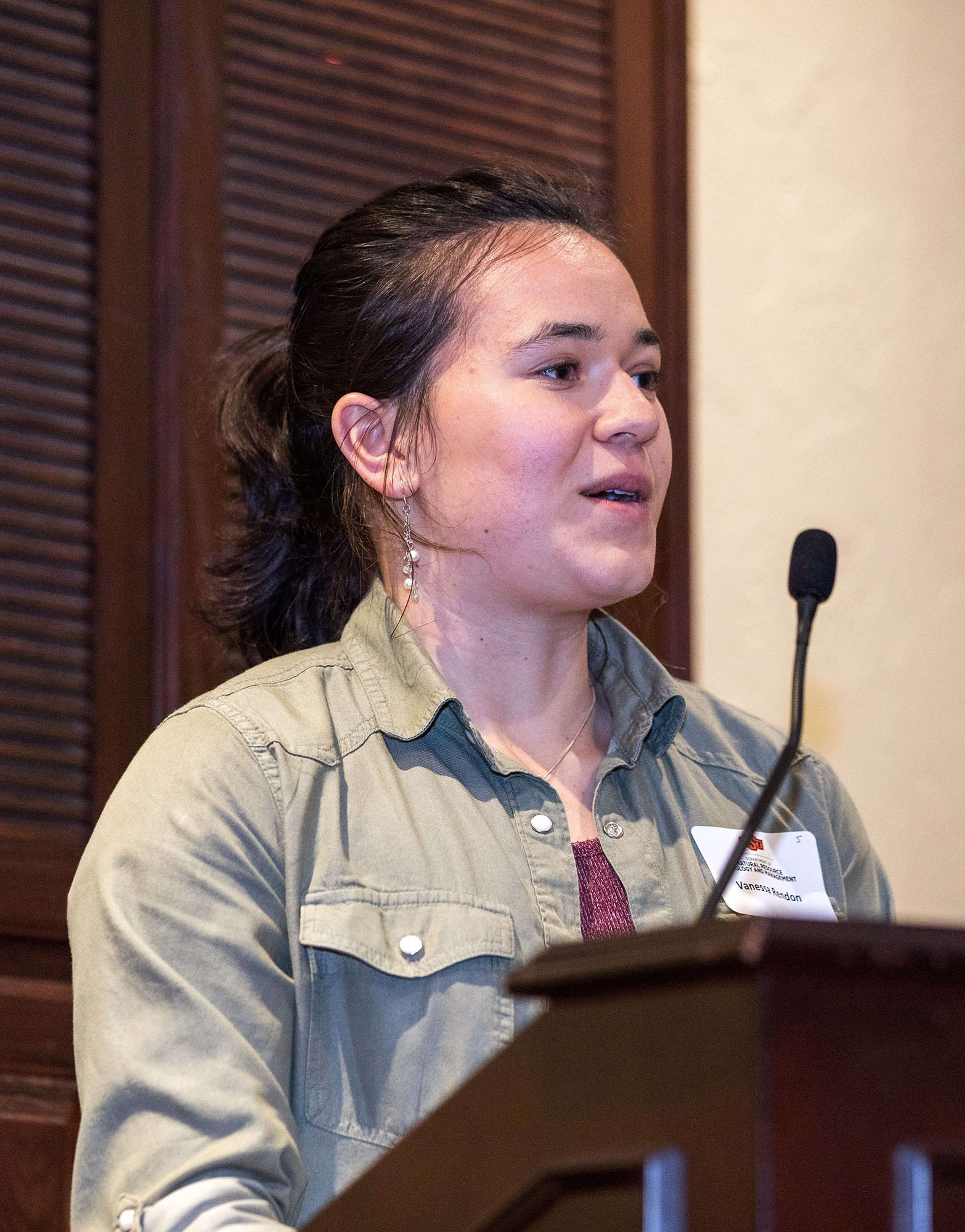 Vanessa Rendon speaking behind the podium.