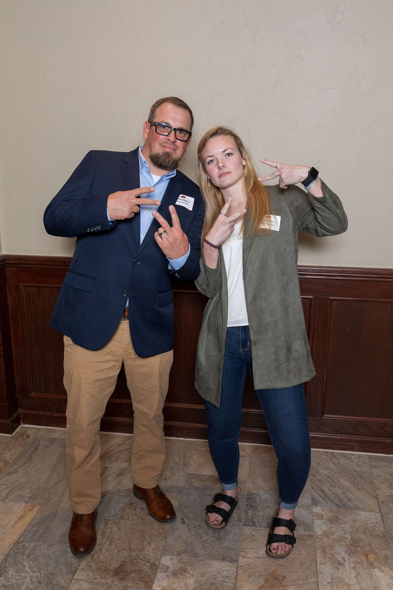 Rob and a friend posing with hand peace sign.
