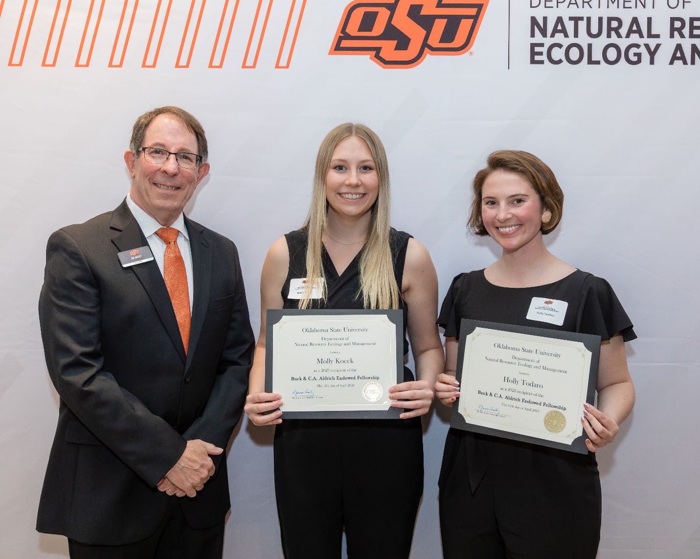 Jim Ansley next Holly mad Molly accepting their Graduate Student Scholarship award.