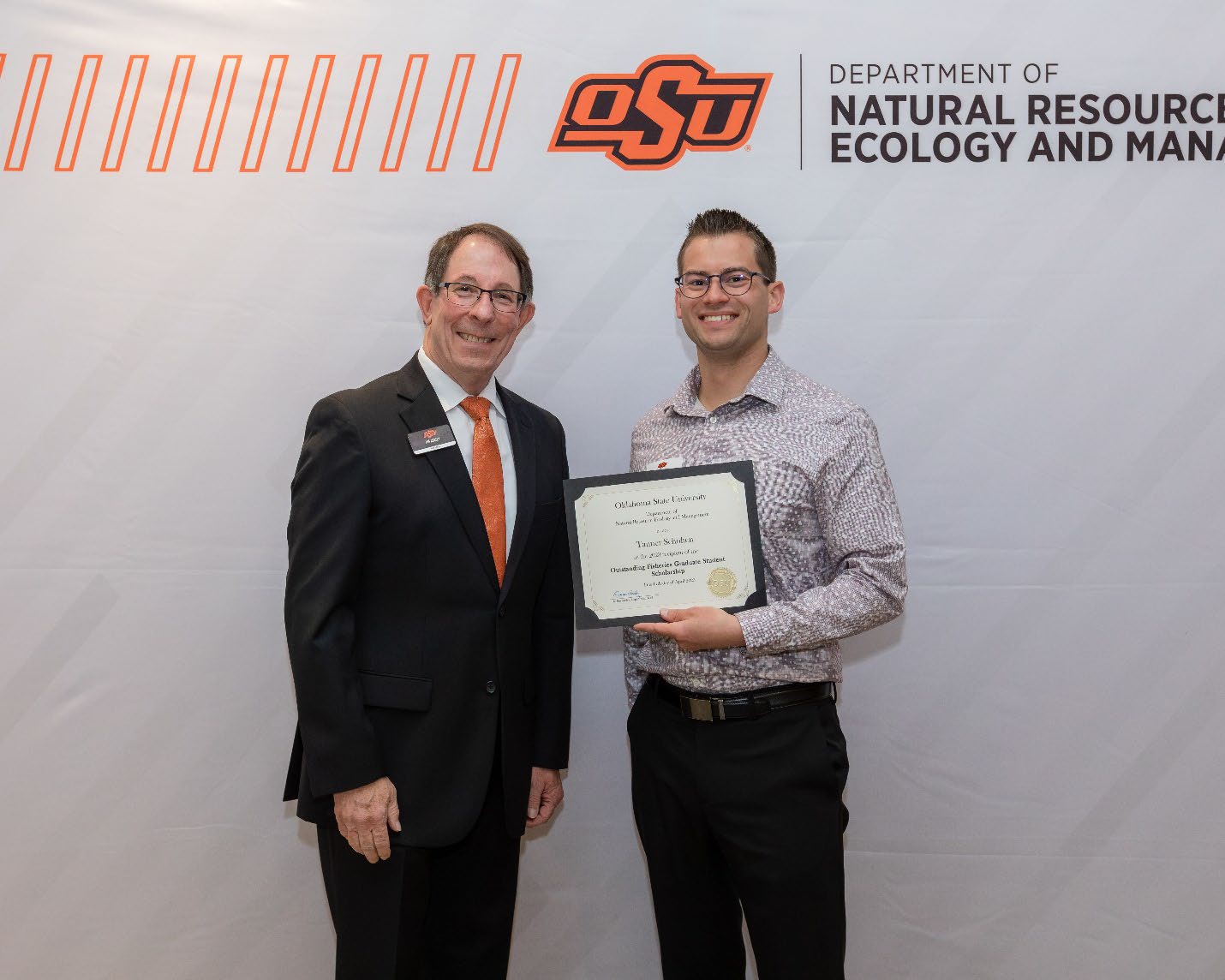 Jim Ansley next to Tanner Scholten accepting their Graduate Student Scholarship award.