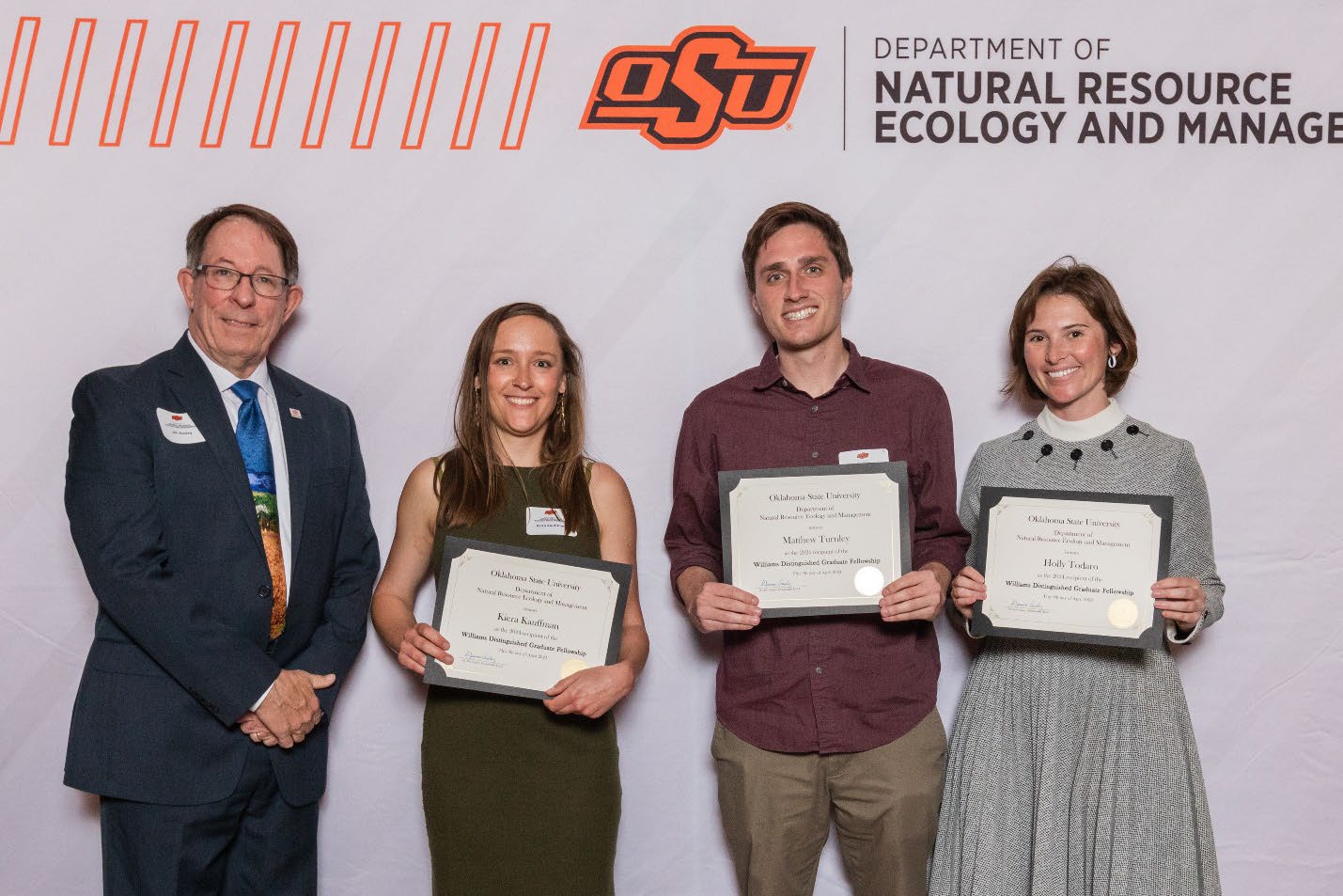 Dr. Jim Ansley, Kiera, Matthew and Holly holding their awards.