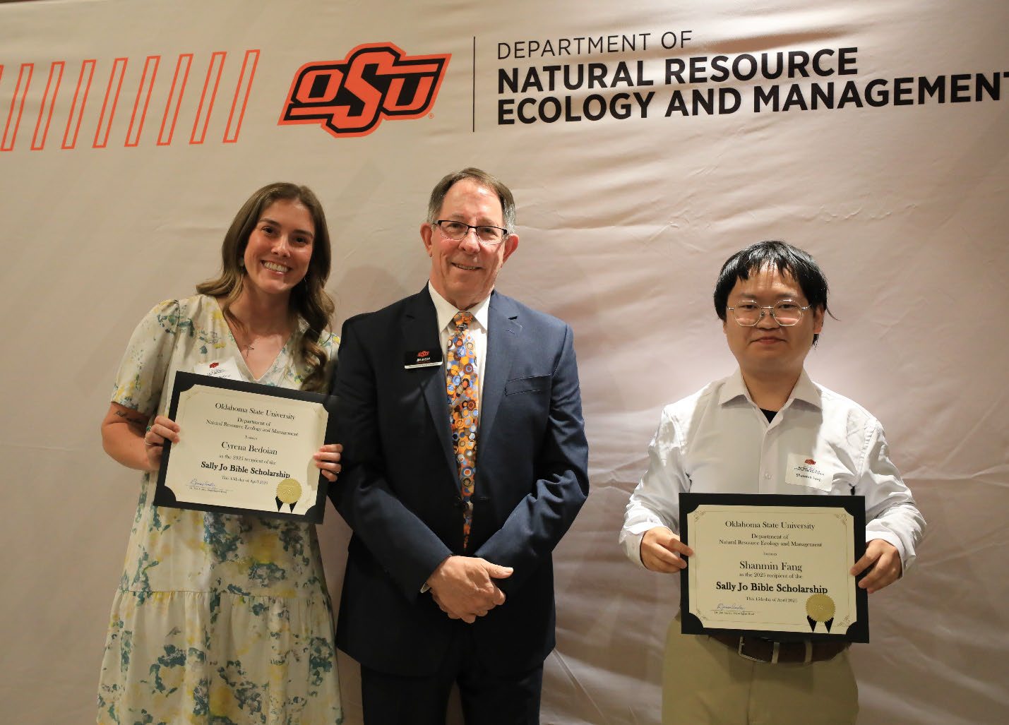 Cyrena Bedoian and Shanmin Fang showing off their award with Dr. Jim Ansley.