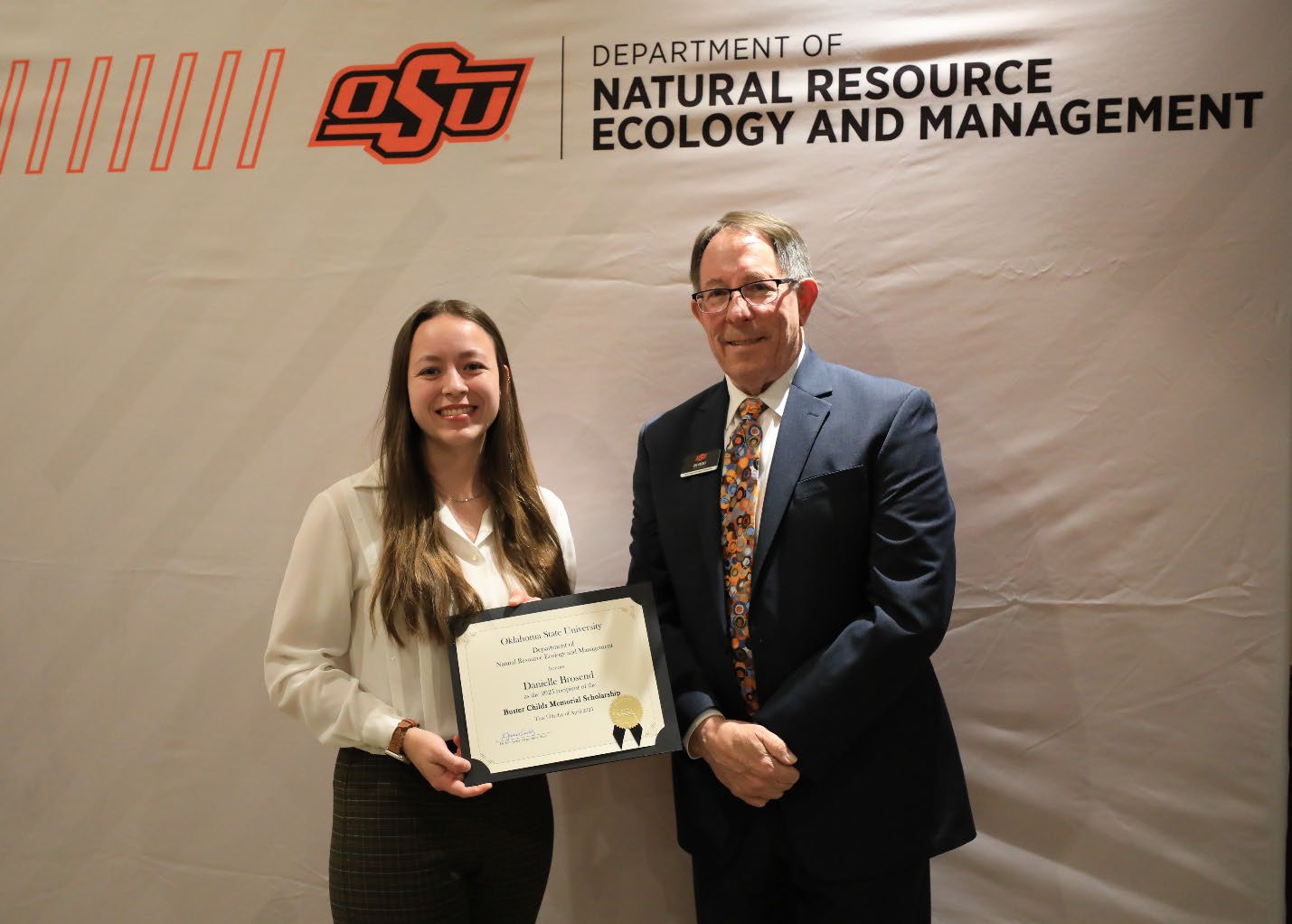 Danielle Brosend holding her award next to Dr. Jim Ansley.