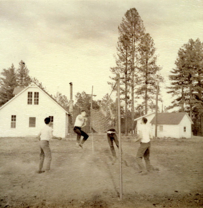 Students playing voleyball outside.
