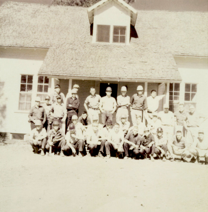 A group of students outside in front of a house.