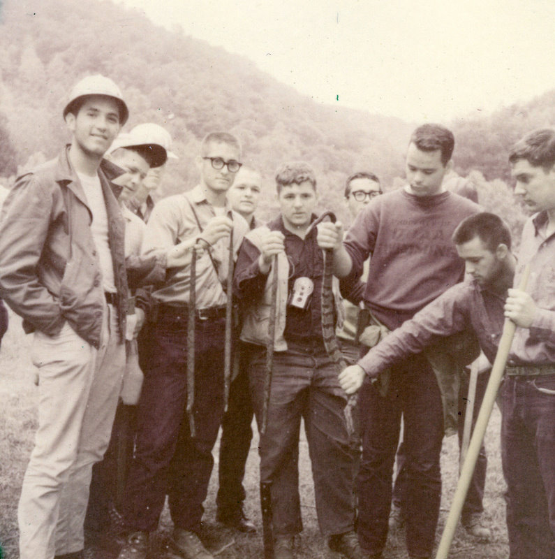 A group of people standing wearing hardhats.