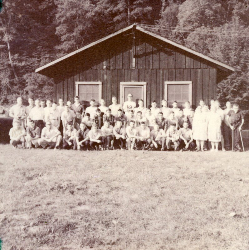 A large group of people outside smiling at the camera.