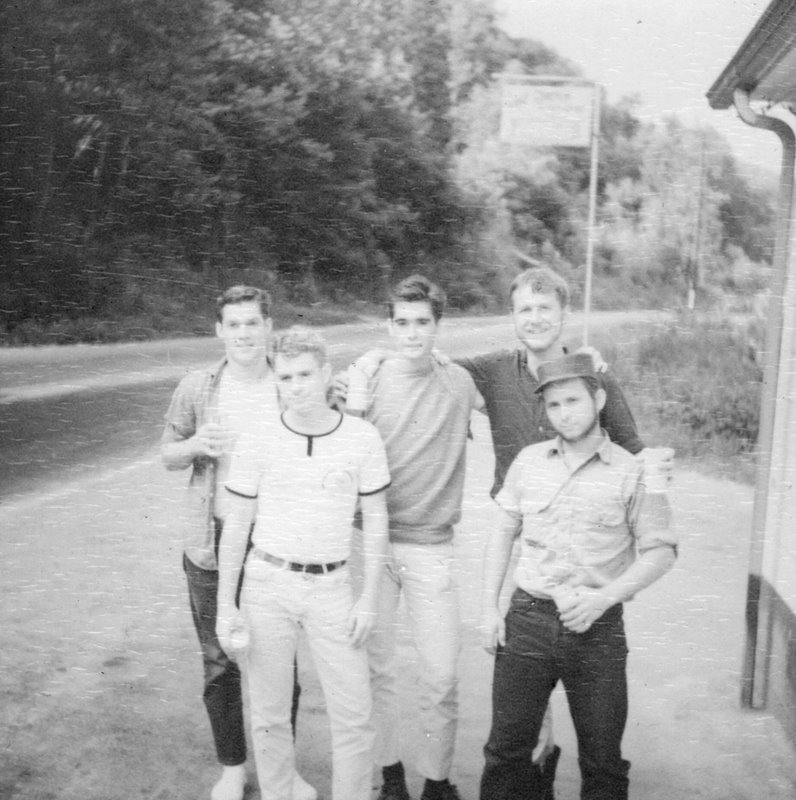 A group of men standing to post for the camera.