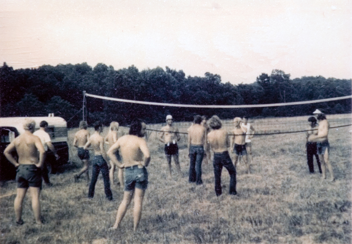 A group of students playing volleyball outside.