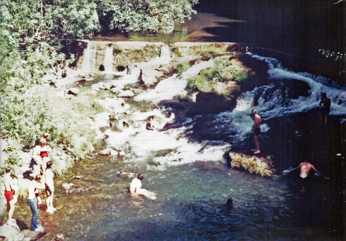 Top down view of a stream, as students enjoy their time by the water.