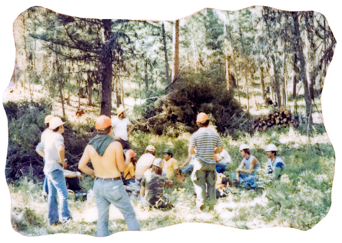 A group of people wearing hardhats outside.