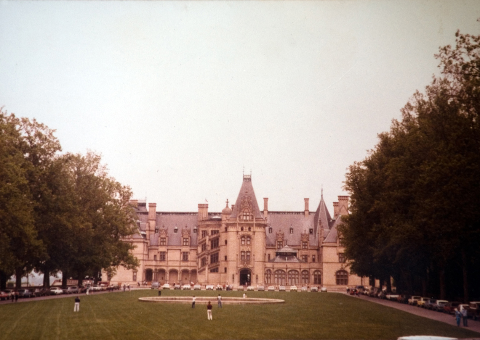 A large building with green grass in the front.