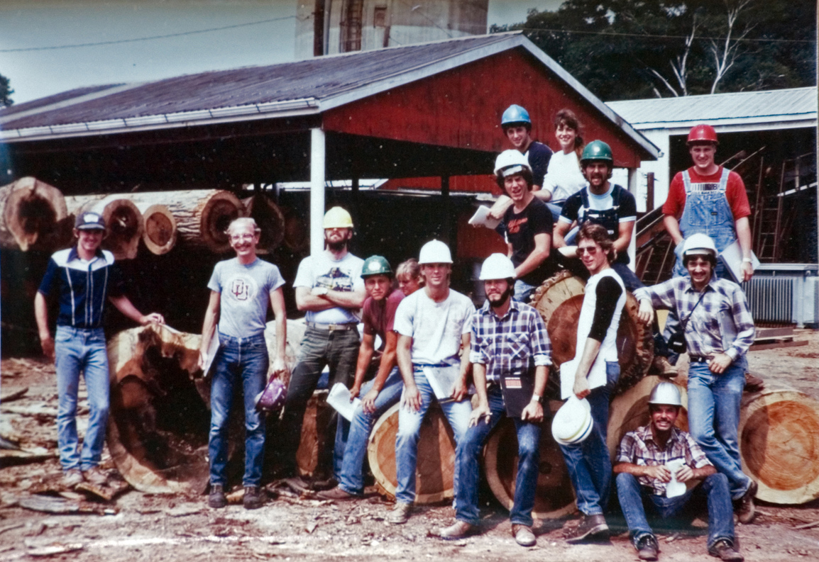 Students in hardhats pose for a photo at the jobsite.
