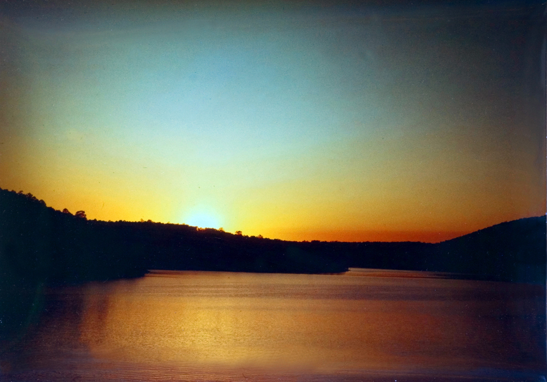 Scenic view of a sunset on a lake backdrop.