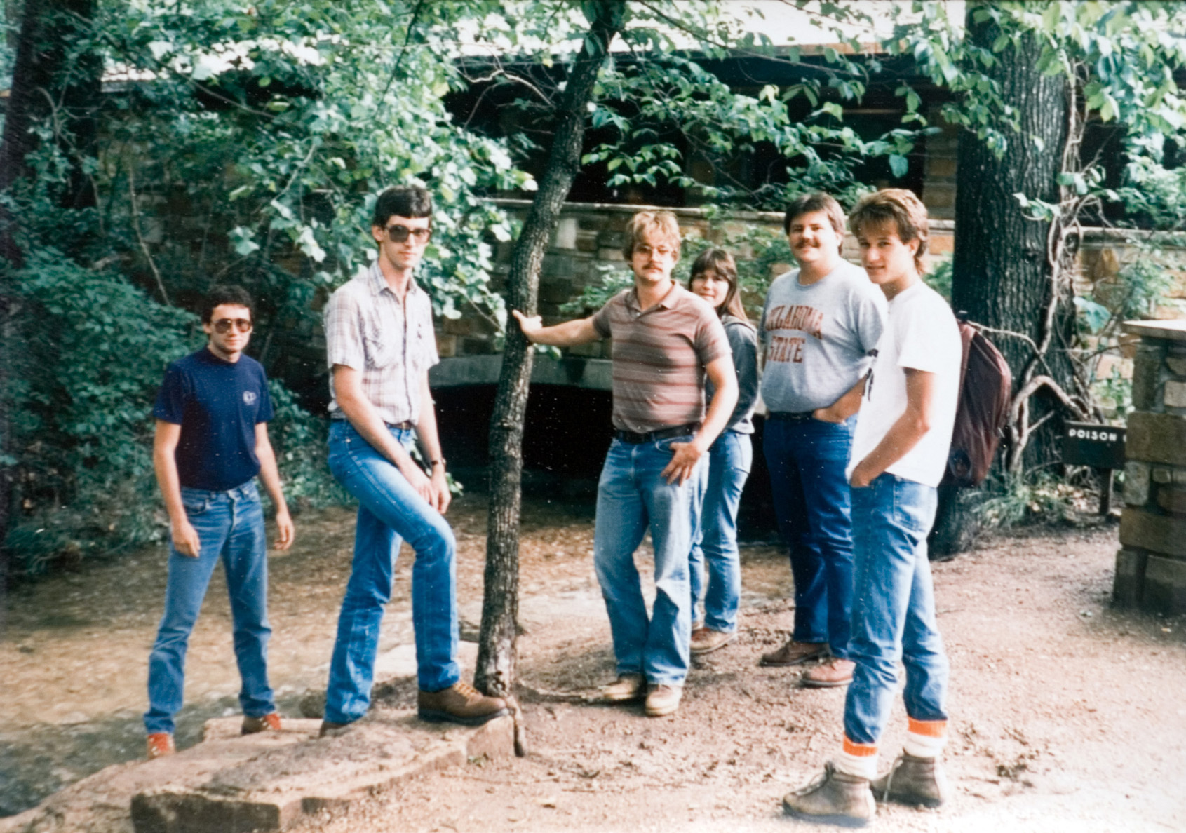 Six students posing next to a tree on the camp grounds.