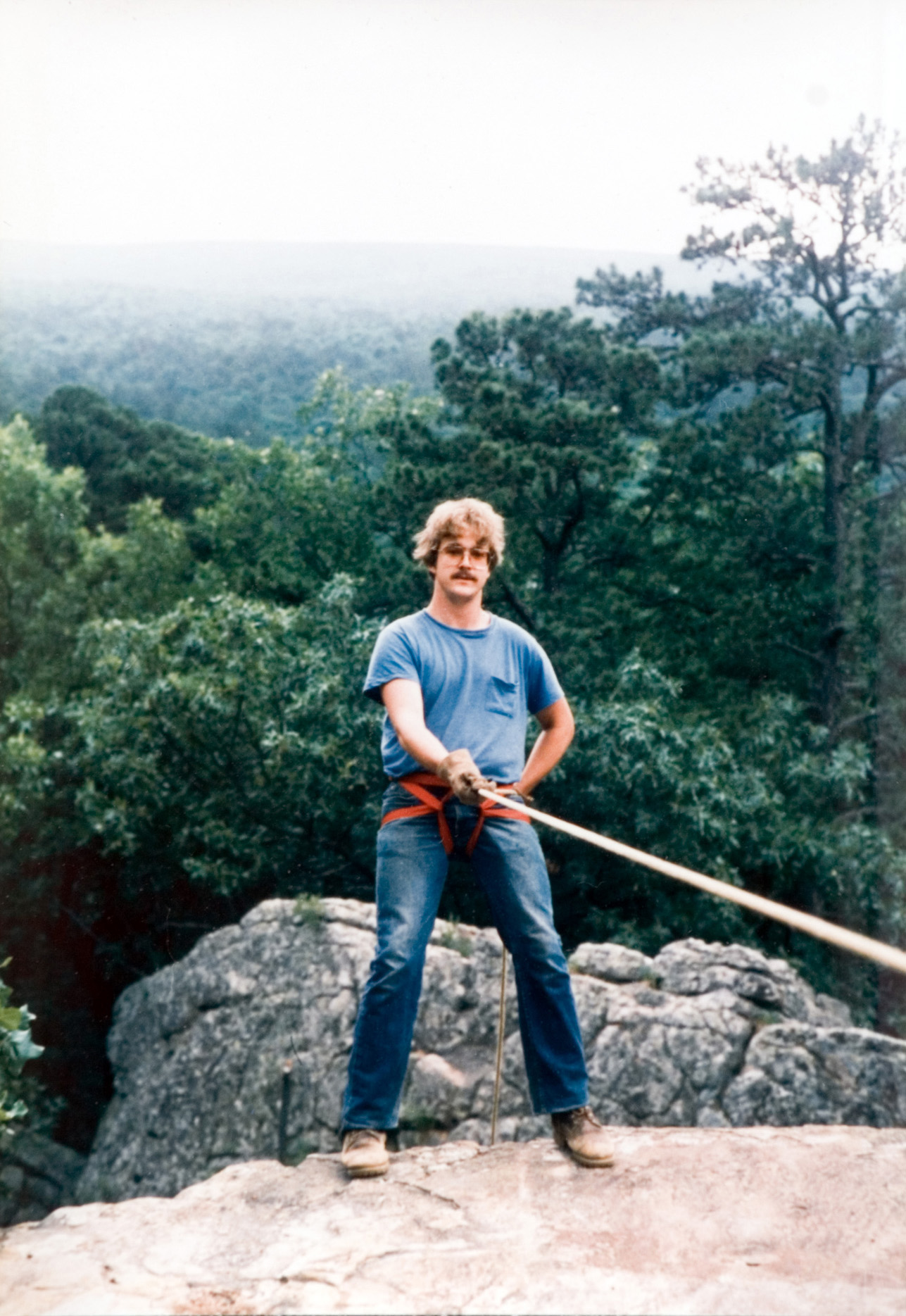 A group of seven students posing in front of the Crosset Experimental Forest Station sign.