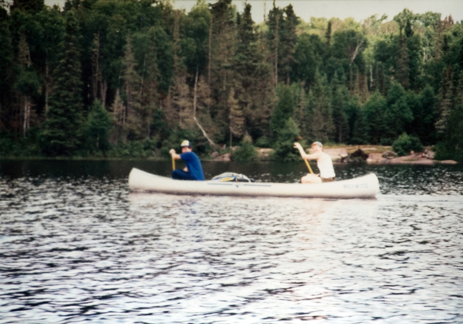 Two students spotted rowing their canoe through the water.