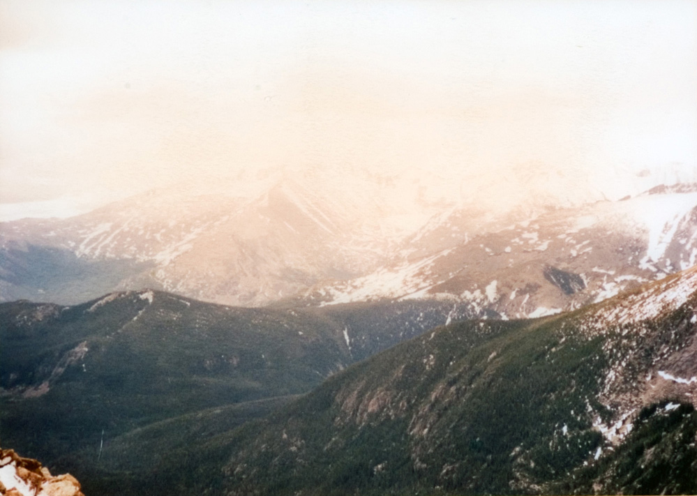 Scenic view of mountains and a hazy pink sky.