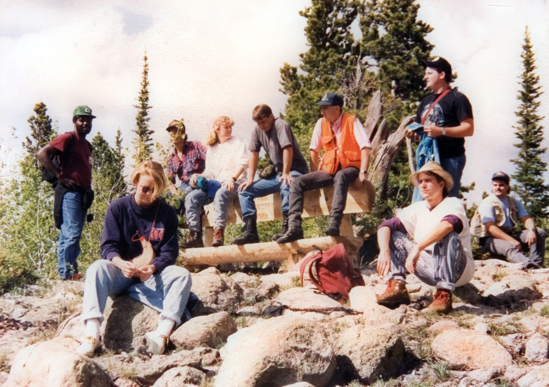 Students rest on the rocks during a hike.