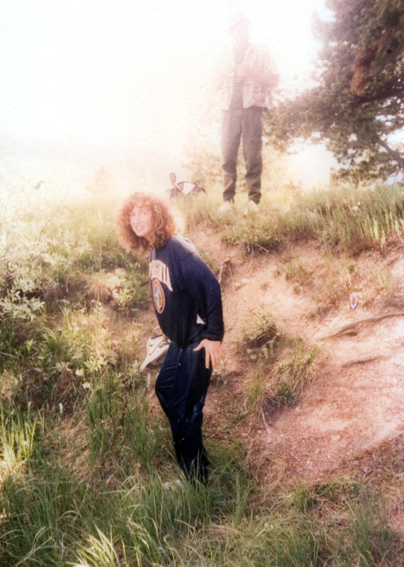 A students stops on the trail for a photo.
