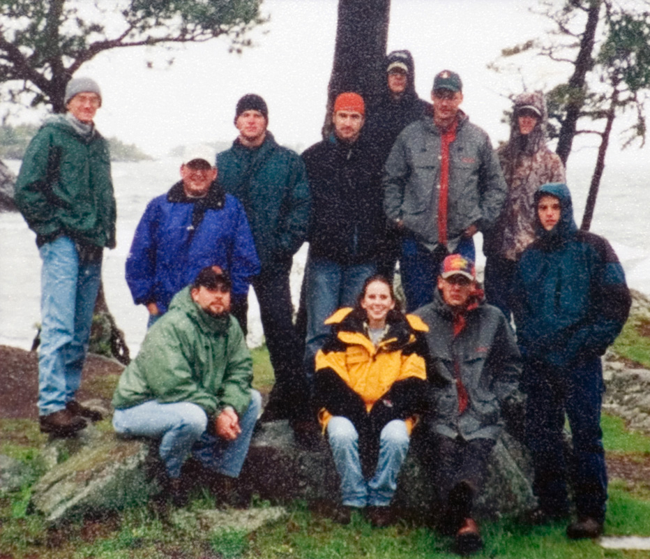 A group of 11 students at the forestry camp gathered together as they pose for a photo.