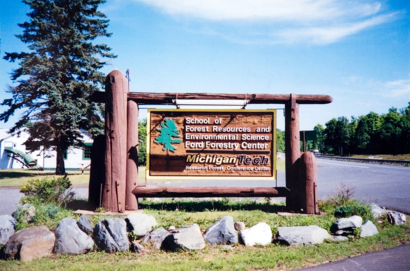 A large wooden Forestry Center welcome sign in Michigan.
