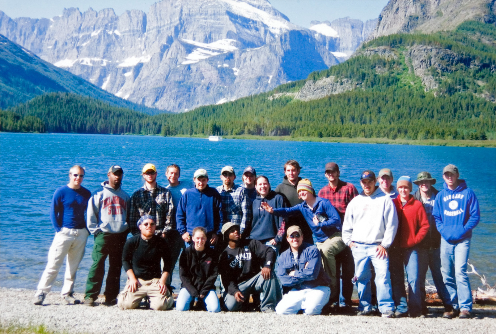 Forestry camp group gathered for a photo by a scenic view of a lake.