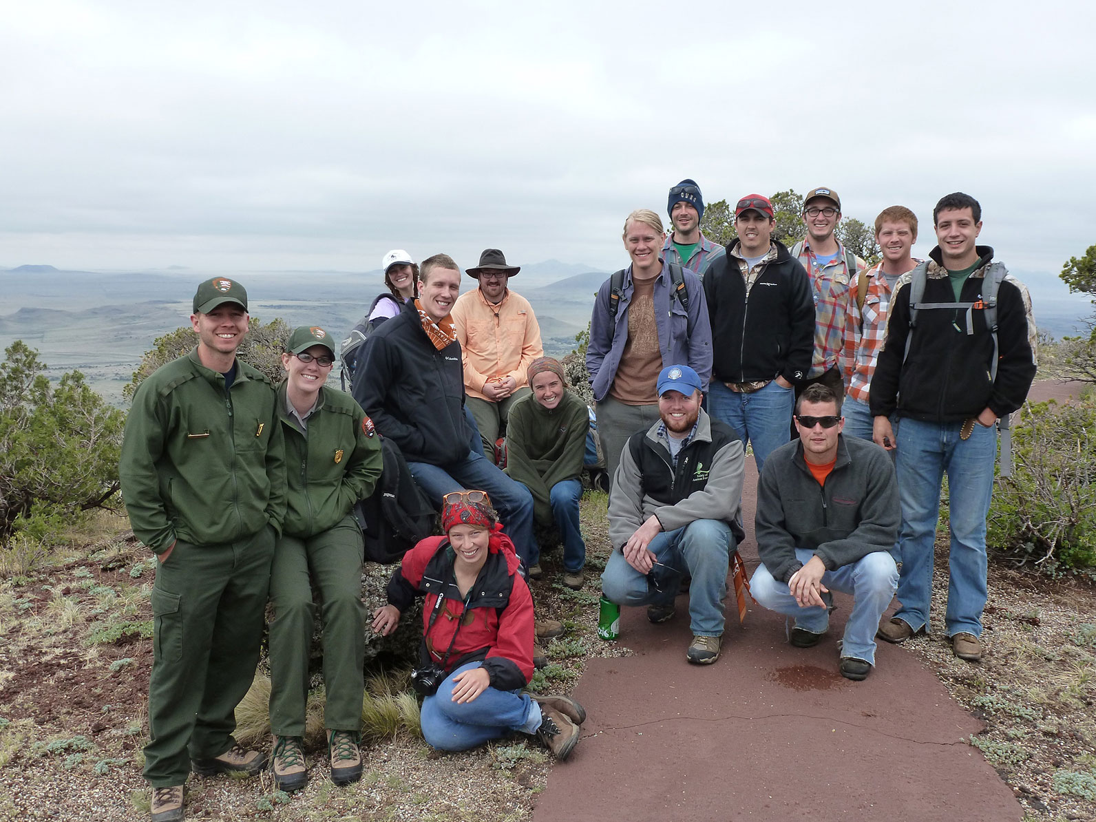A group of participants at an overlook of a mountain range.