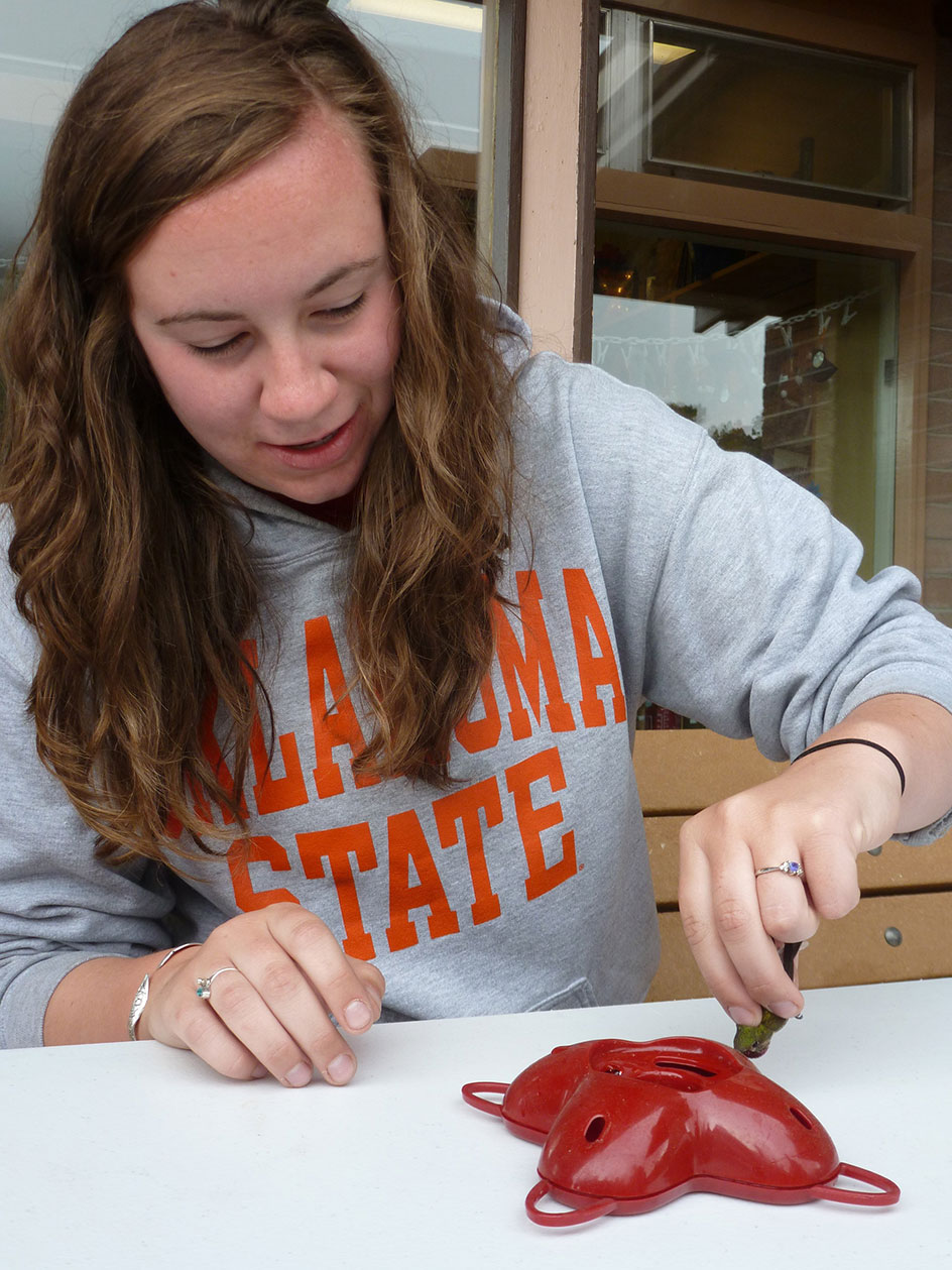 A student posed sitting at lab table.