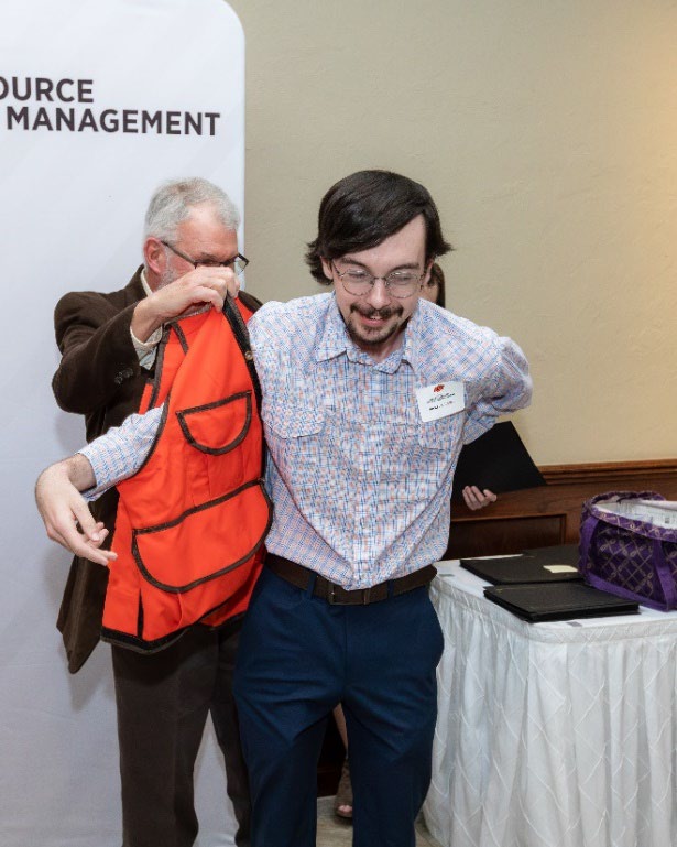 Tom Kuzmic is putting on a orange west on Jackson Russell