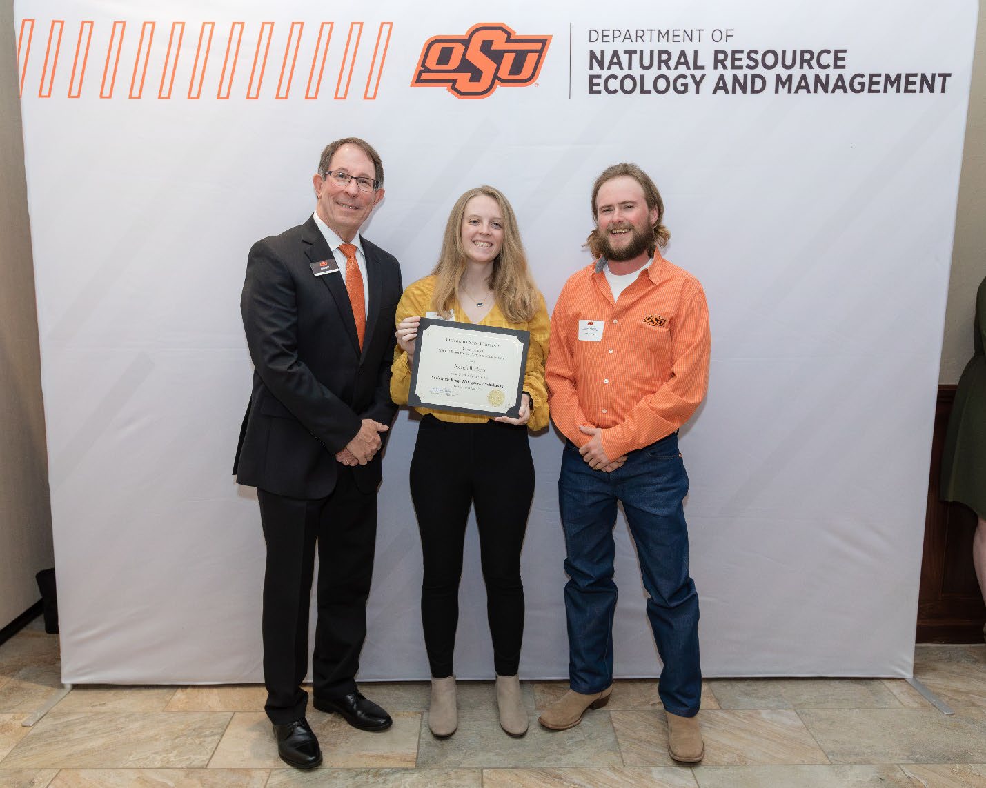 Kendall Hays and Jack Tidwell with Jim Ansley accepting her Undergraduate Student Scholarship award.