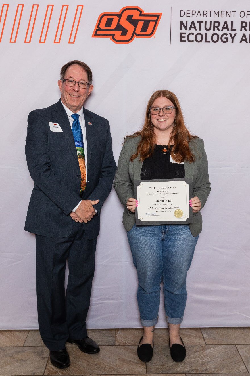 Morgan holding her award next Dr. Jim Ansley.