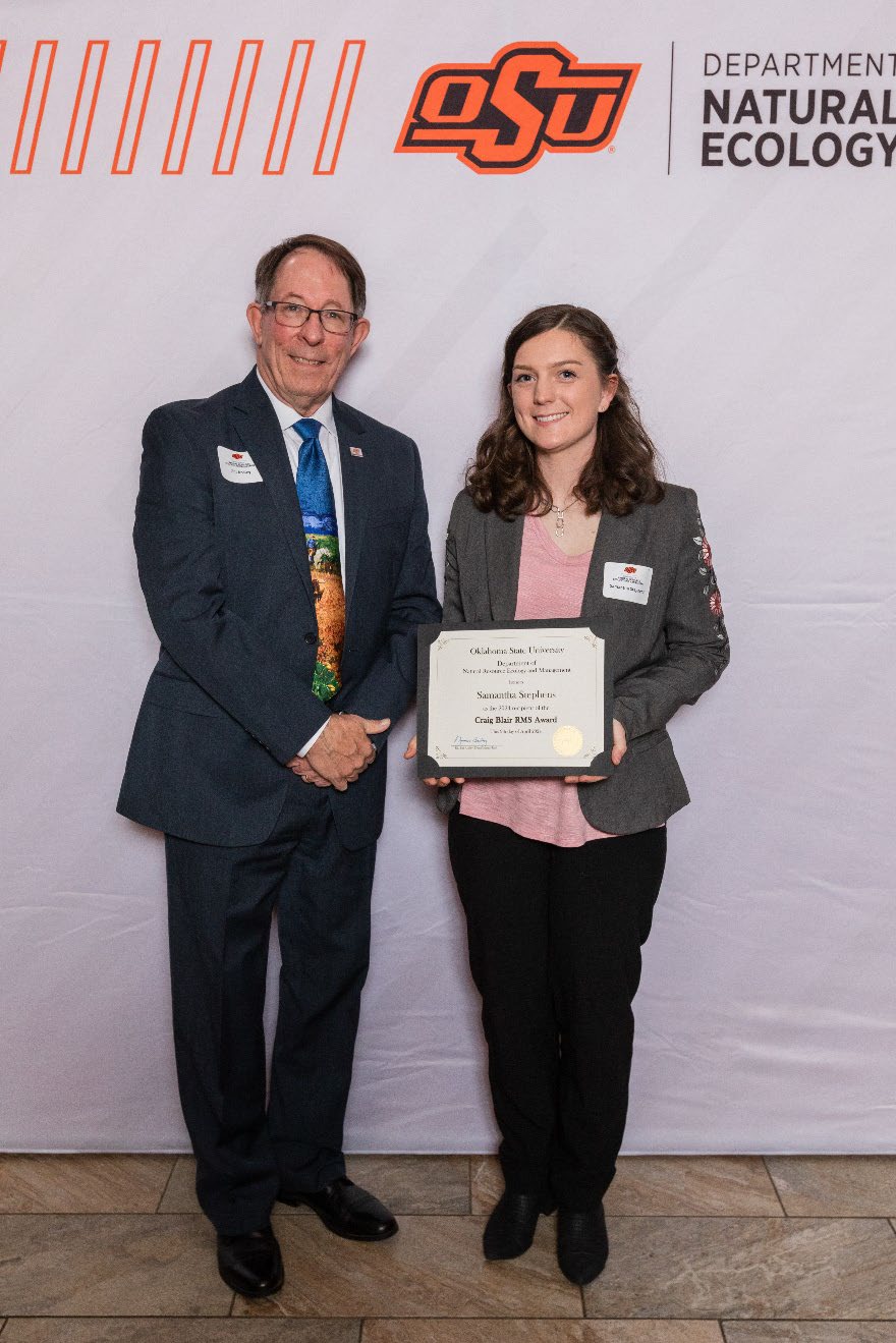 Samantha is accepting her award from Dr. Jim Ansley.