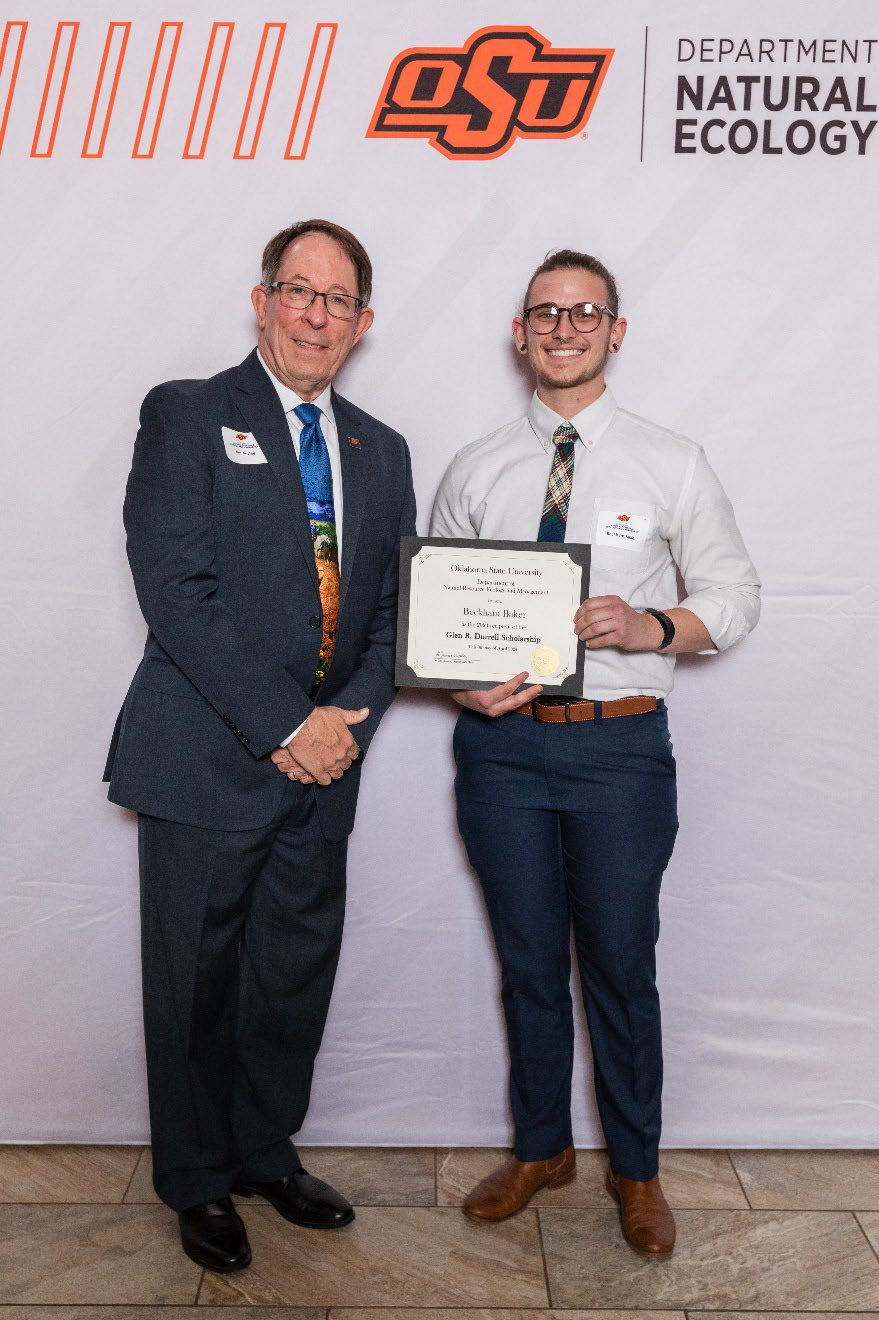Beckham holding his award next to Dr. Jim Ansley.