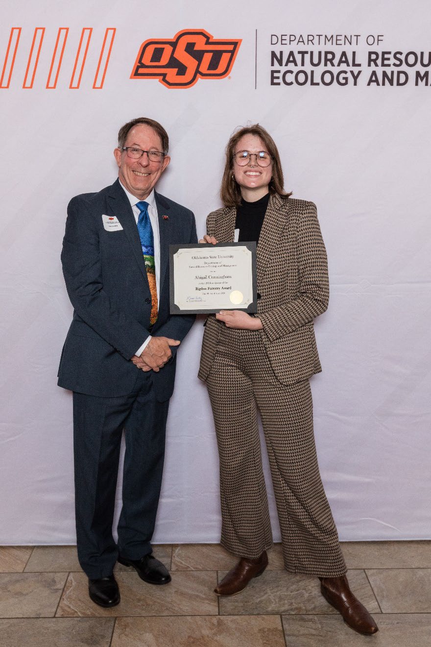 Abigail Cunningham holding her award next to Dr. Jim Ansley.
