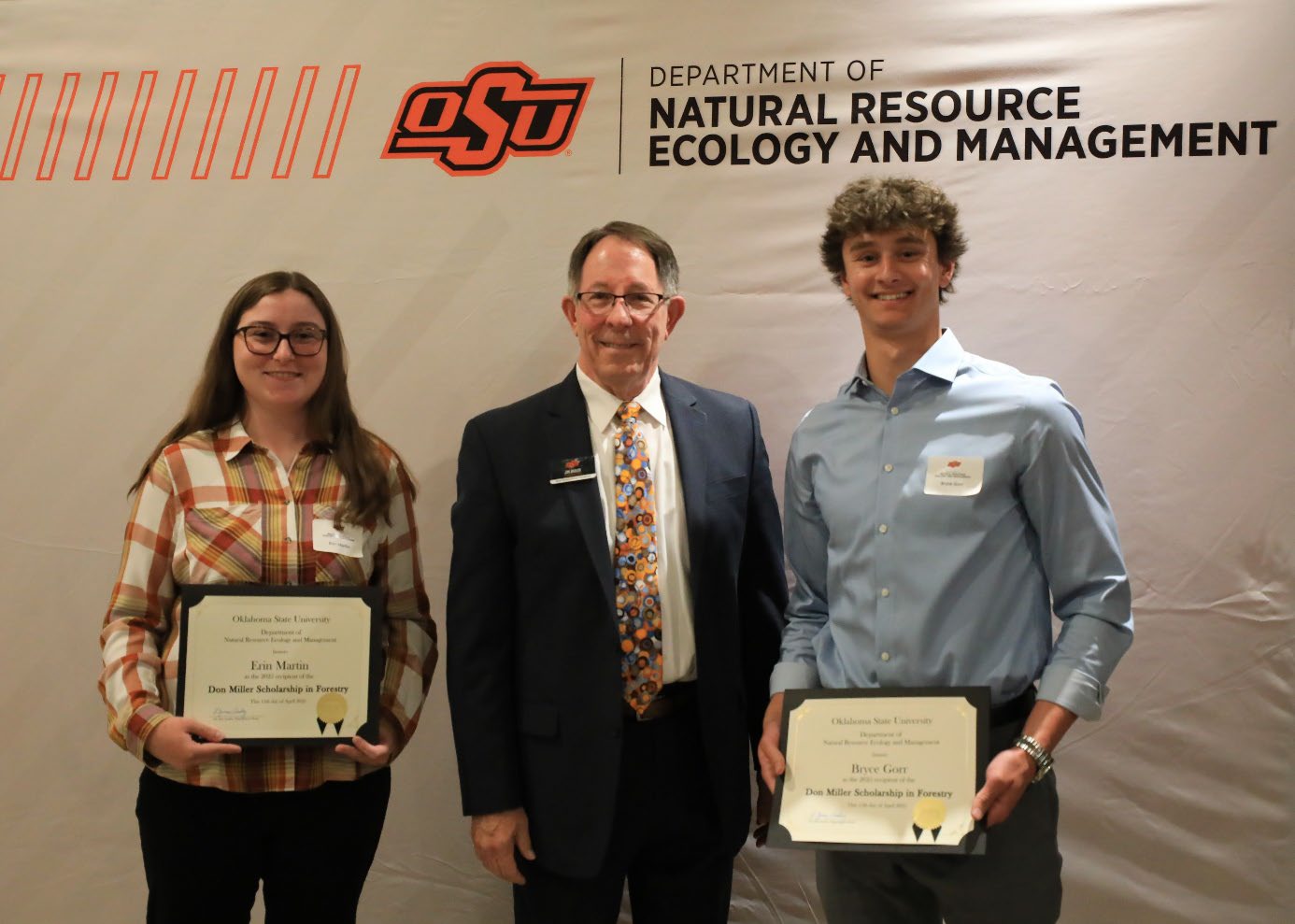 Erin Martin and Bryce Gorr holding their awards with Dr. Jim Ansley.