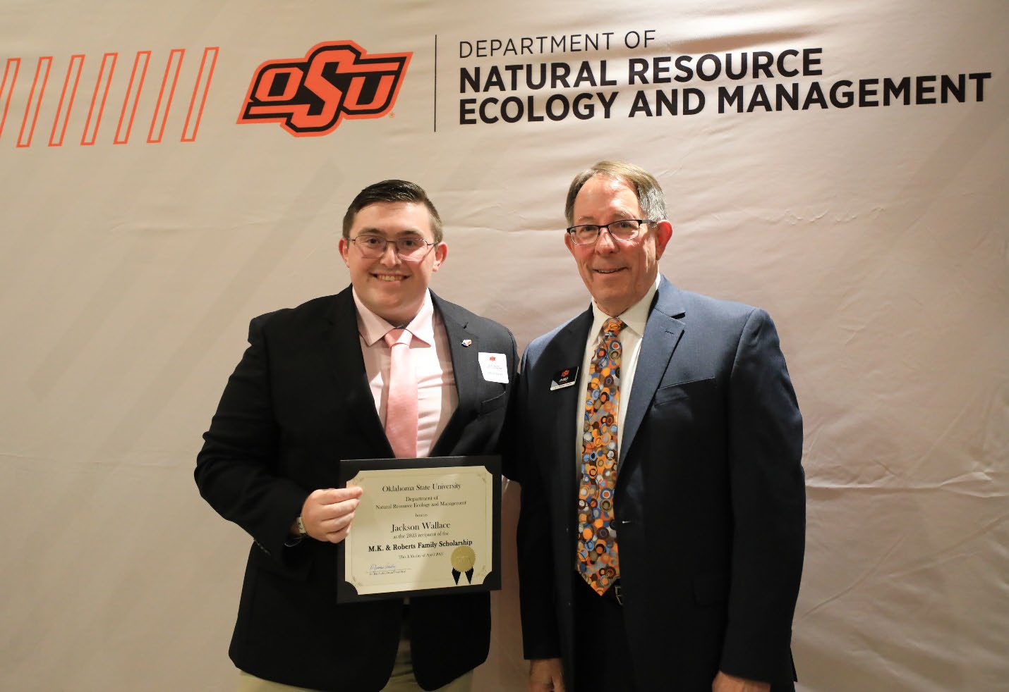 Jackson Wallace holding his plaque next to Dr. Jim Ansley.