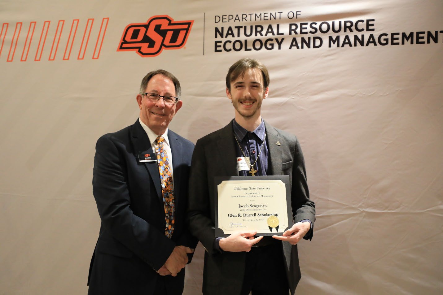Jacob Seagraves holding his award next to Dr. Jim Ansley.