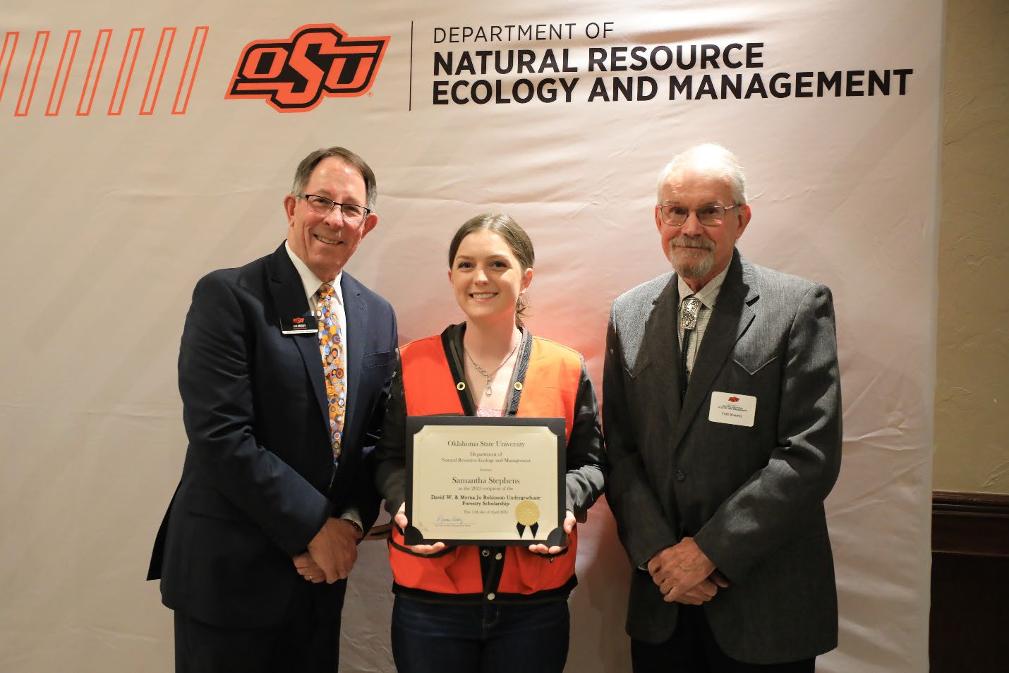 Samantha Stephens with her award between Dr. Tom Kuzmic and Dr. Jim Ansley.